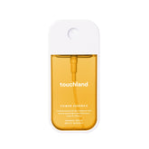 Touchland Mango Mojo fragrance mist bottle highlighting tropical mango notes for an uplifting scent