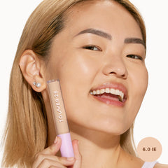 Tower 28 Swipe Serum Concealer shade 6.0 IE on skin shows warm, light coverage.