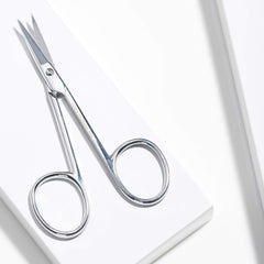 Tweezerman cuticle scissors trimming dead skin safely with sharp tips.