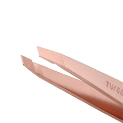 Tweezerman rose gold petite slant tweezers—aligned tips for reliable hair removal.