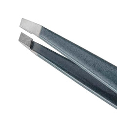 Tweezerman blue stone tweezer angle view emphasizes ergonomic grip for controlled plucking