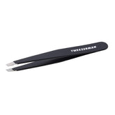Tweezerman stainless-steel slant tweezer closeup highlighting precise alignment for root hair removal.
