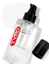 TYMO Weightless Hair Oil bottle closeup highlights lightweight nourishment for shiny, frizz-free hair.