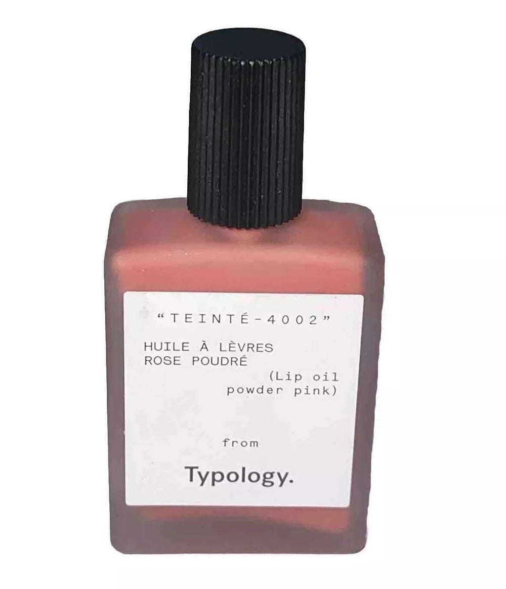 Typology Tinted Lip Oil Powder Pink shade 2 swatch on lips for hydrated shine