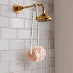 UMAID Salt Buddy in bath tub releasing minerals for relaxation