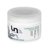 Unwash Charcoal Detox Scalp Scrub bottle close-up showing detoxifying charcoal for a refreshed scalp.
