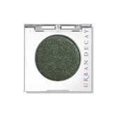 Urban Decay 24/7 Eyeshadow Psych warm-green metallic swatch highlights vibrant color with longwear potential.