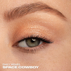 Urban Decay Moondust Space Cowboy champagne gold sparkle under bright lighting