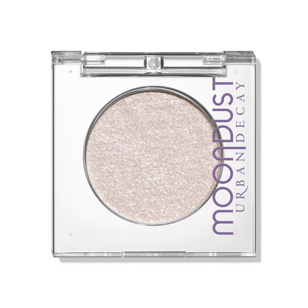 Urban Decay Moondust Space Cowboy swatch showing champagne gold sparkle for luminous eyes.