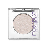 Urban Decay Moondust Space Cowboy swatch showing champagne gold sparkle for luminous eyes.