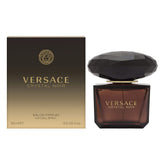 Versace Crystal Noir bottle close-up showing elegant glass and amber hue for evening wear.