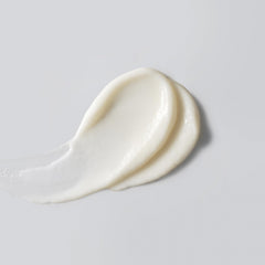 Versed Good Defense sunscreen texture close-up showing hydrating, creamy lotion for daily use.