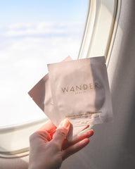 Wander Beauty Baggage Claim rose-gold-foil patches on skin during use.