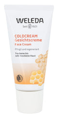 Weleda balm being smoothed onto cheeks for facial hydration.