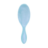 Wet Brush Original Detangler close-up on blue glitter waves for gentle detangling on wet and dry hair.