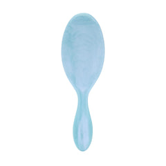 Wet Brush Original Detangler close-up on blue glitter waves for gentle detangling on wet and dry hair.