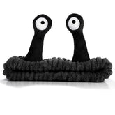 WLLHYF spa headband with snail cartoon design keeps hair away during skincare.