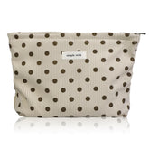 Wudygirl corduroy makeup bag beige polka dot close-up showing soft exterior for everyday use.