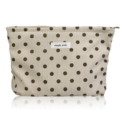 Wudygirl corduroy makeup bag beige polka dot close-up showing soft exterior for everyday use.