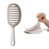 Xinqirity self-cleaning hair brush front view enables quick cleanup after styling.