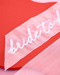 xo-fetti bachelorette party bow accessory ready to wear as a fun hair accent.