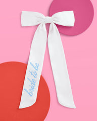 xo, fetti white satin hair bow close-up embroidery detail ideal for engagement shoots