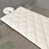 XOLLOZ double-sided massage table pad on a table with plush fleece for warmth
