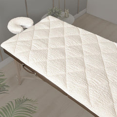 XOLLOZ double-sided massage table pad on a table with plush fleece for warmth
