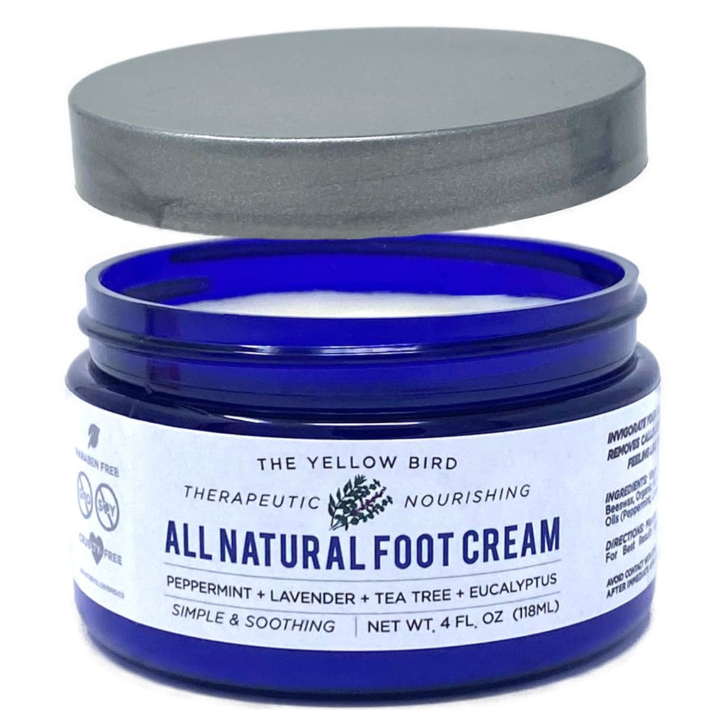 The Yellow Bird tea tree foot cream jar closeup showcases natural, hydrating moisture.