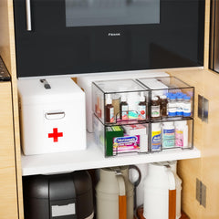 Yieach stackable organizers in a medicine cabinet for orderly storage.