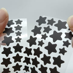 Close-up of a star-shaped ZHAOLIESM patch applied to the skin for adhesion.