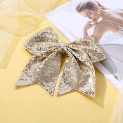 Zolyco cheer bow gold worn by teen, versatile for sports or cheer.