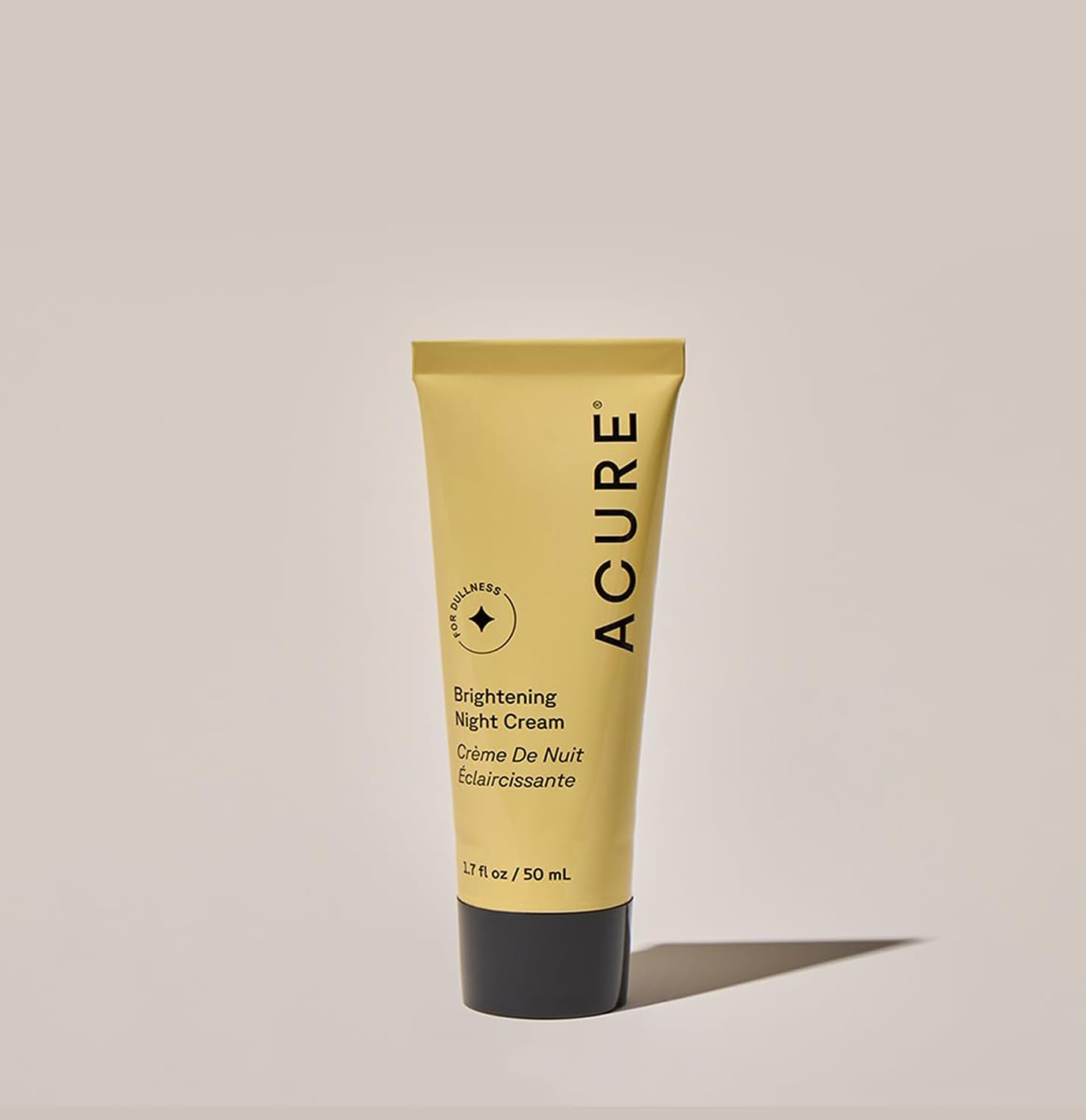 Acure Brightening Night Cream bottle beside nightstand as part of a nighttime routine.