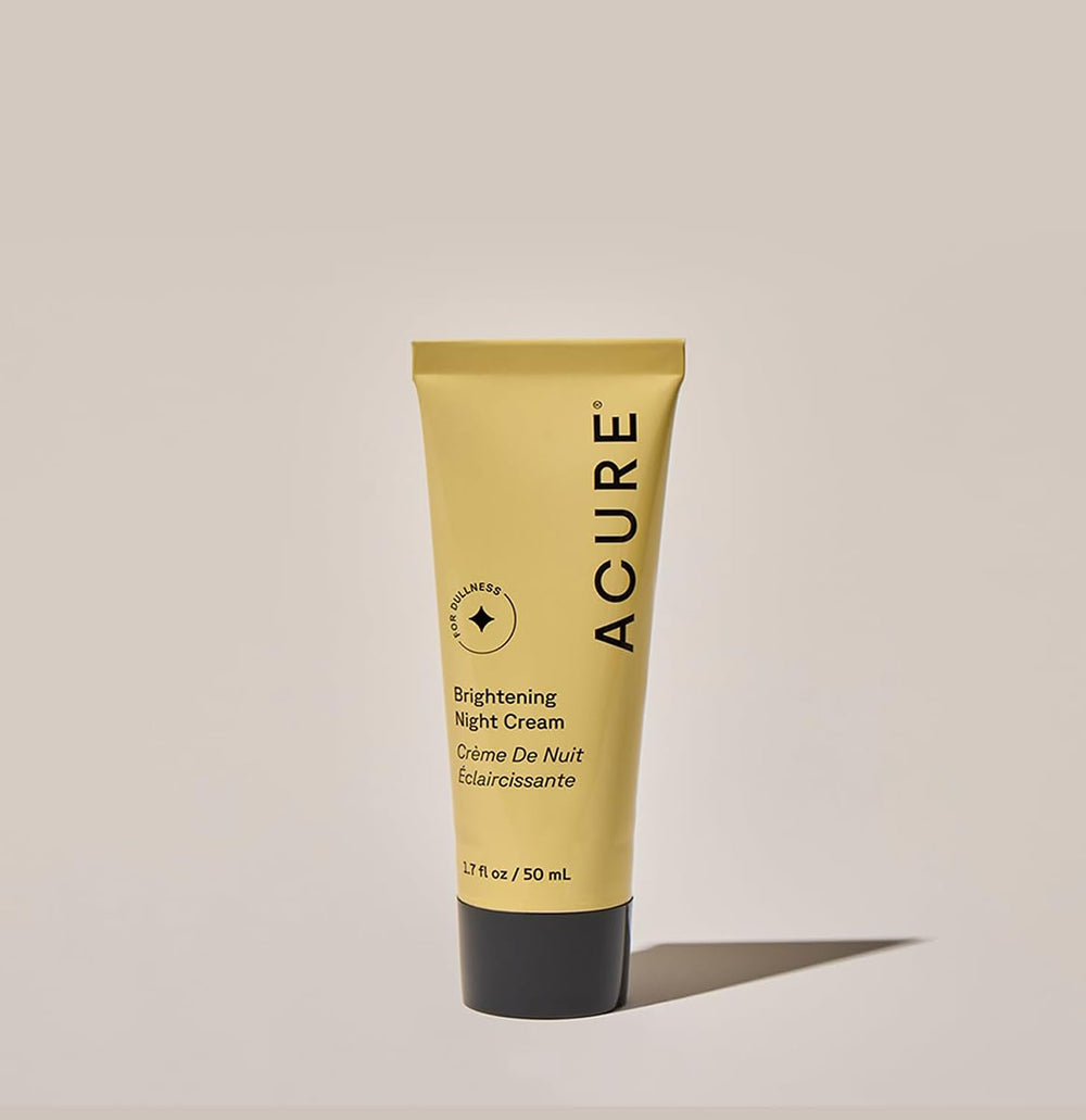 Acure Brightening Night Cream bottle beside nightstand as part of a nighttime routine.