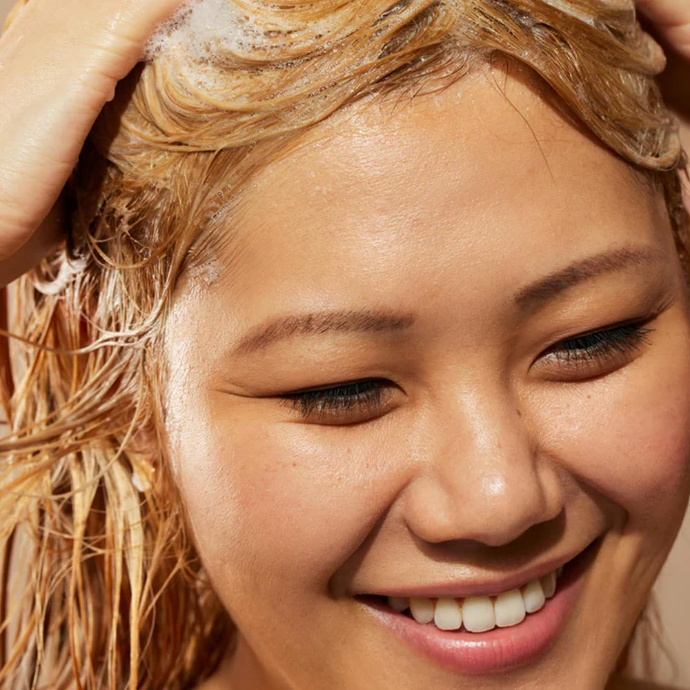 Acure Simply Smoothing Shampoo coconut water detail emphasizes hydrating refresh without weighing down.