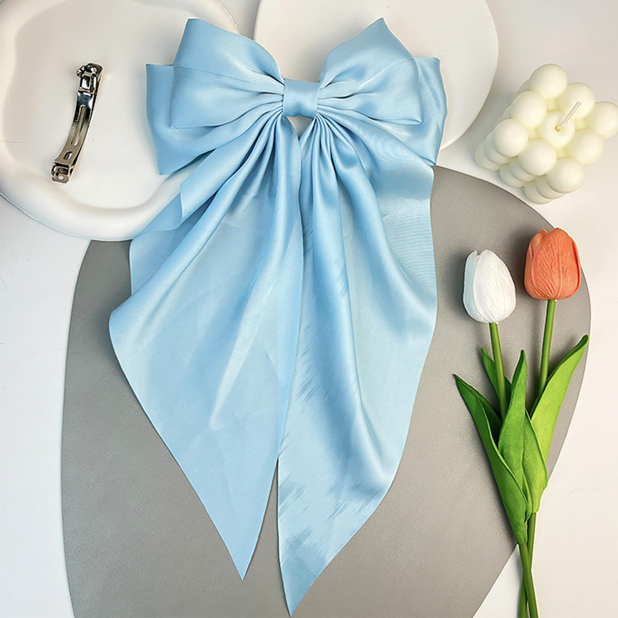 AEGYPIUS big blue bow barrette metal clip close-up shows secure grip