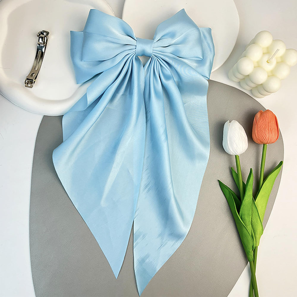 AEGYPIUS big blue bow barrette metal clip close-up shows secure grip