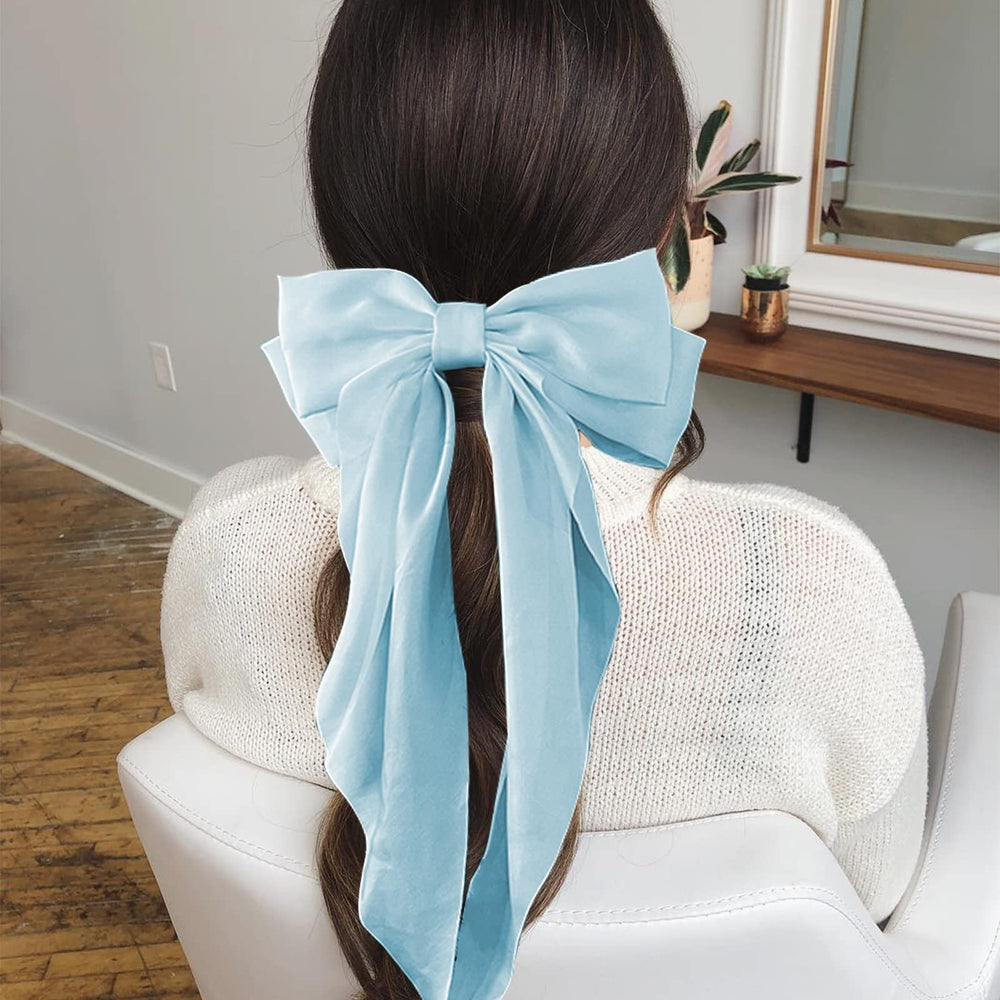 AEGYPIUS ivory grosgrain wrapped bow close-up highlights smooth finish