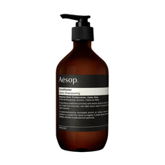 Aesop conditioner bottle closeup with citrus-woody aroma for refreshing nourishment.