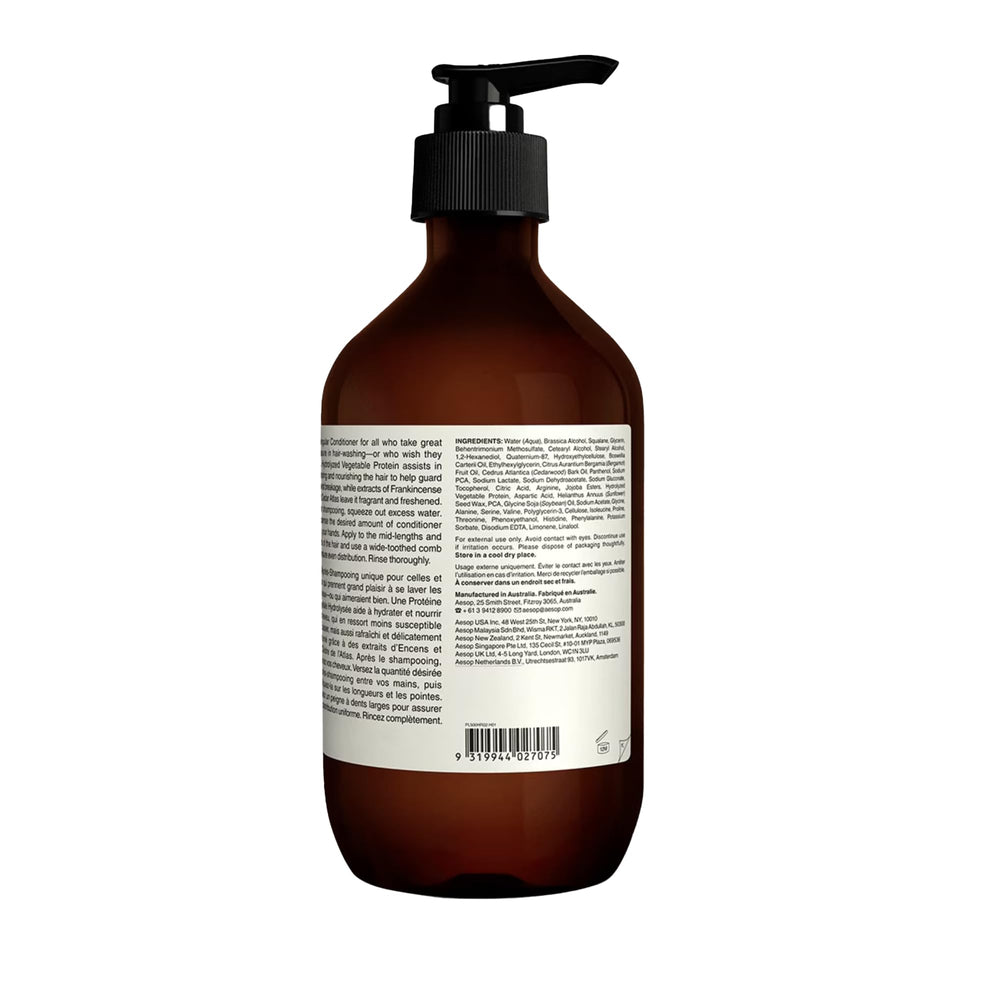Aesop conditioner with citrus-earthy-woody scent inviting a spa-like sensory ritual.