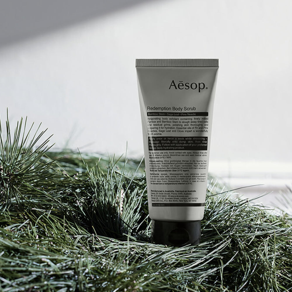 Aesop Redemption Body Scrub in use for gentle exfoliation on damp skin