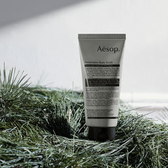 Aesop Redemption Body Scrub in use for gentle exfoliation on damp skin