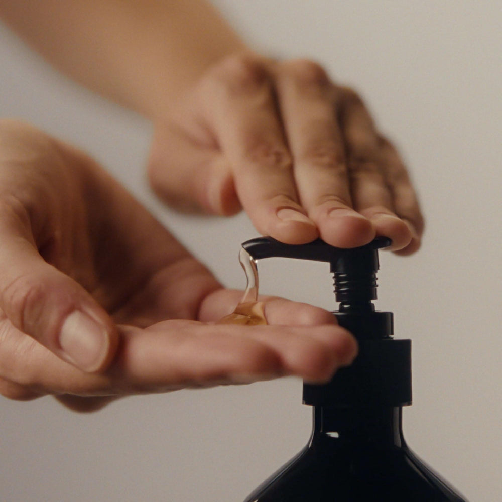 Aesop Resurrection Aromatique Hand Wash lathering close-up demonstrates rich foam for cleansing.