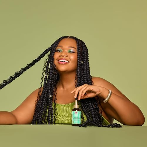 African Pride Feel It Formula Oil on curls for definition and frizz control.