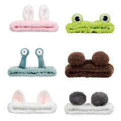 AIBFRID green frog headband keeps hair away during skincare.