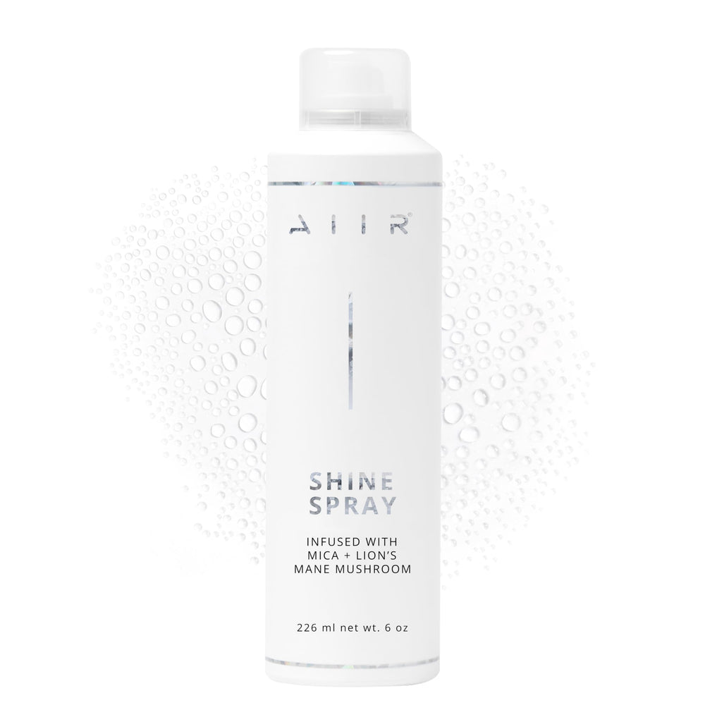 AIIR Shine Spray bottle close-up delivers glossy finish and frizz control.
