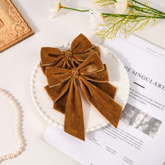 Aileam brown velvet bow clip secured with a sturdy alligator clip keeps hairstyles neat.
