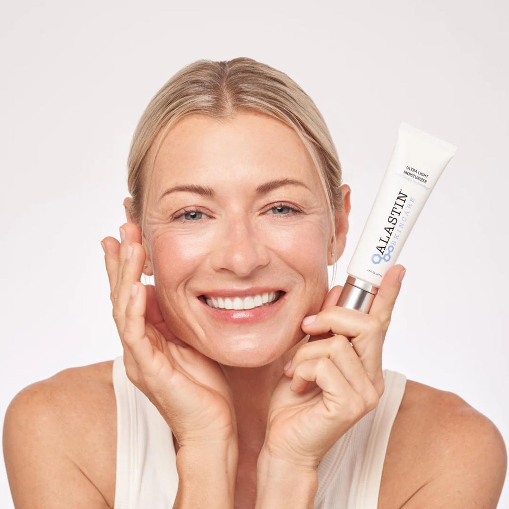ALASTIN Ultra Light moisturizer on cheek demonstrates fast-absorbing daily hydration.