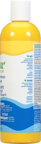 Close-up of hair application using Alba Botanica Ocean Surf conditioner
