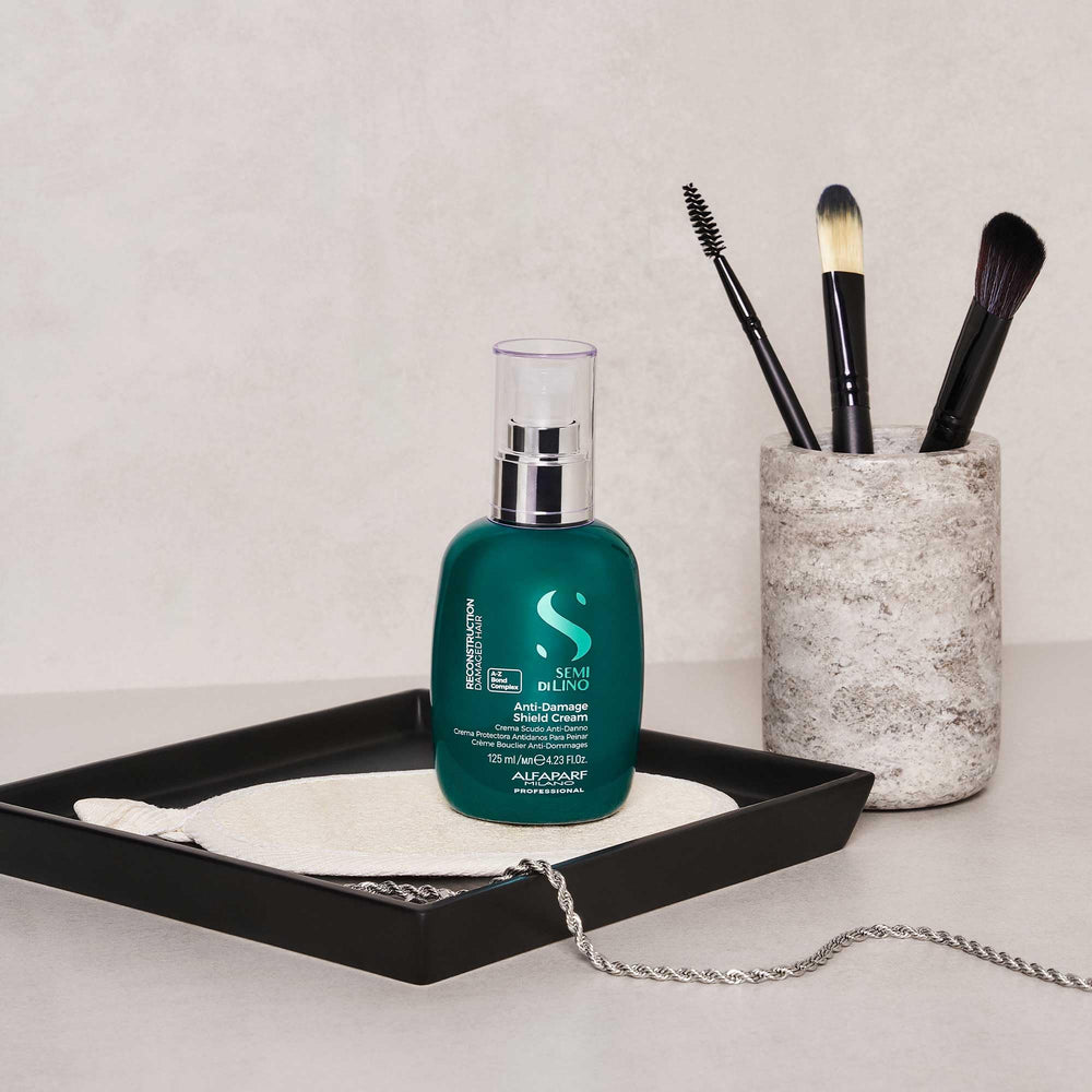 Alfaparf Milano reconstruction cream application shot emphasizes color-safe care